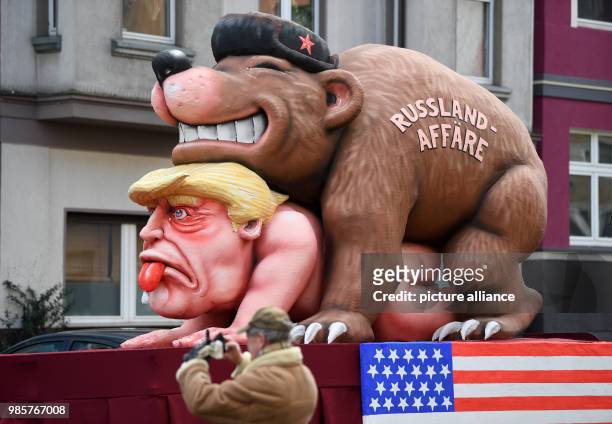 Political caricature float featuring a "Russian bear" on top of the figure of "Donald Trump, the 45th president of the United States" taking part in...