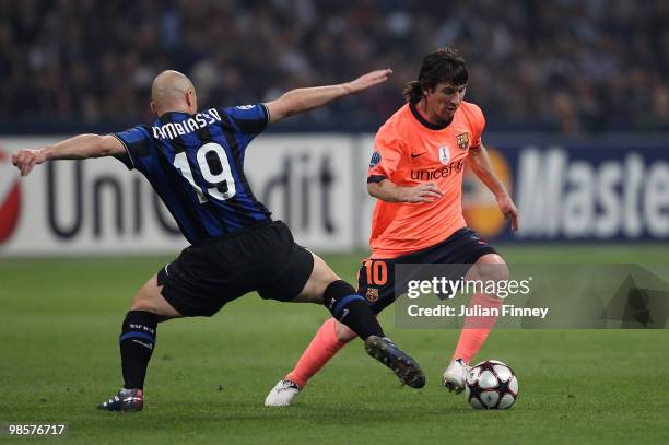 Lionel Messi of Barcelona (R goes past Esteban Cambiasso of Inter during the UEFA Champions League Semi Final 1st Leg match between Inter Milan and...