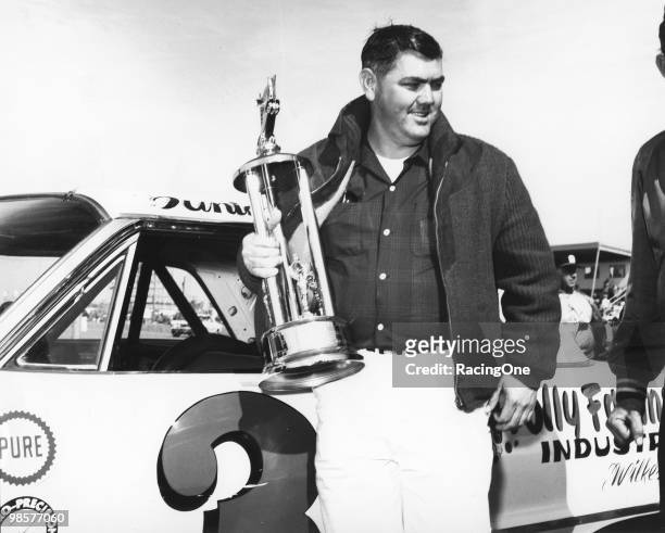 Junior Johnson with his trophy for one of the 125-mile qualifying races for the Daytona 500 at Daytona International Speedway.