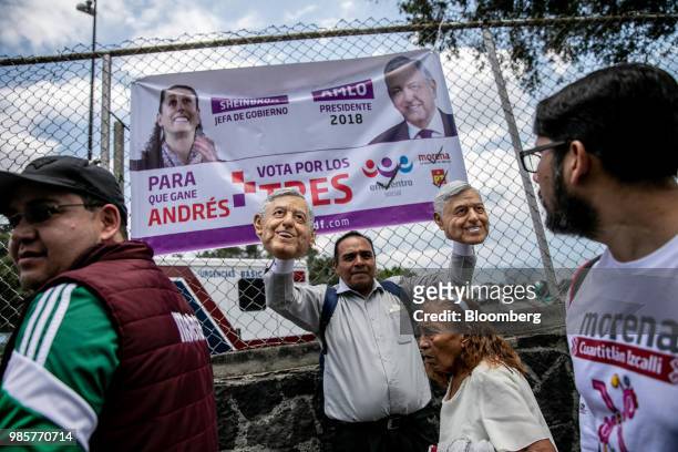 Vendor holds masks in the likeness of Andres Manuel Lopez Obrador, presidential candidate of the National Regeneration Movement Party , ahead of the...