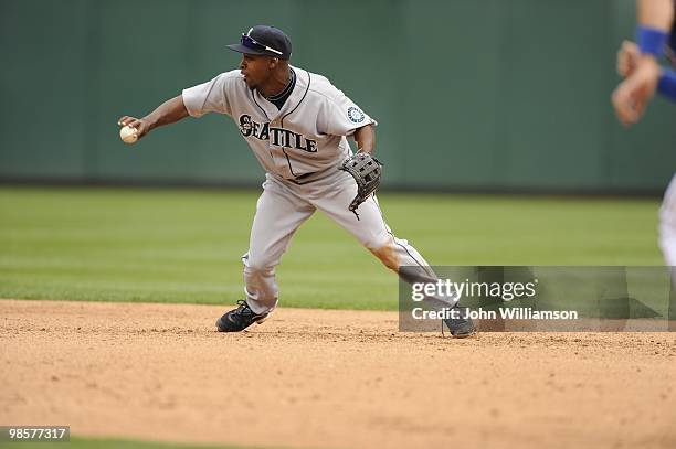 Second baseman Chone Figgins of the Seattle Mariners fields his position as he tosses the ball backhand for the force out at second base after...