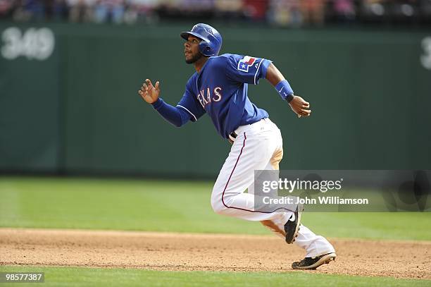 Elvis Andrus of the Texas Rangers runs the bases between first and second as the ball is put in play during the game against the Seattle Mariners at...