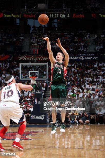 Luke Ridnour of the Milwaukee Bucks shoots a jump shot against Mike Bibby of the Atlanta Hawks in Game One of the Eastern Conference Quarterfinals...