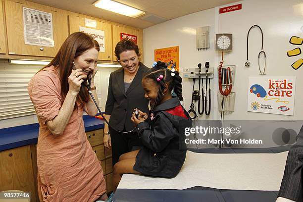 Actress Julianne Moore, Dr. Gracie Delaney, and Khaliyah age 5 tour a Children's Health Fund mobile medical clinic at the Children's Health Fund's...