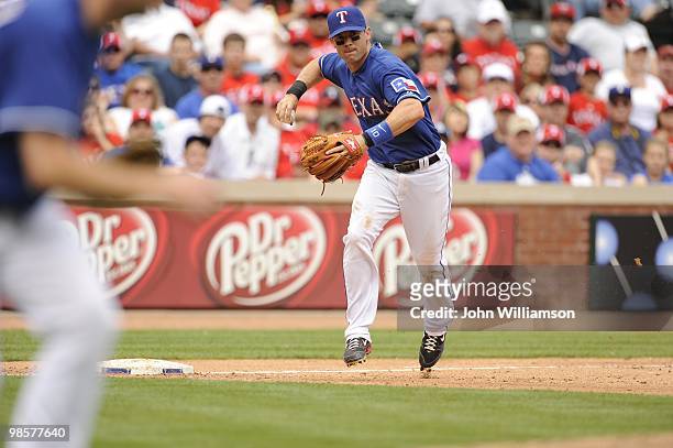 Third baseman Michael Young of the Texas Rangers fields his position as he throws to first base after catching a ground ball during the game against...
