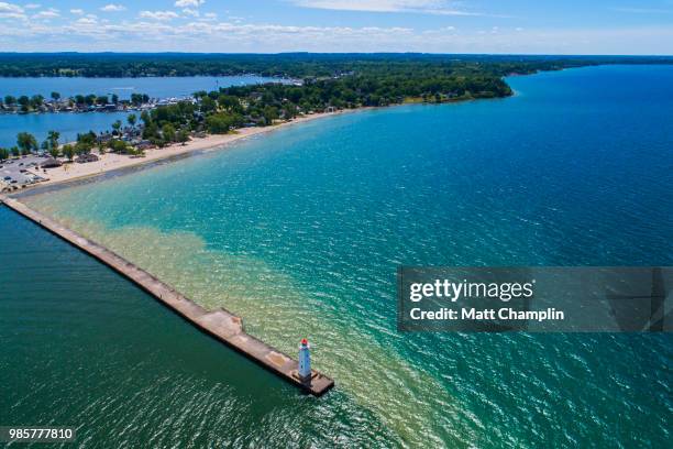aerial of a lighthouse guarding entrance to harbor - lake ontario stock pictures, royalty-free photos & images