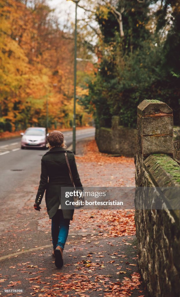 Man Walking On Road During Autumn