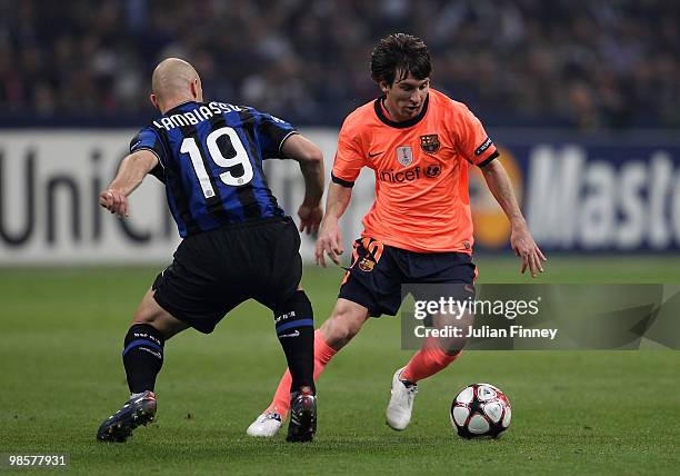 Lionel Messi of Barcelona goes past Esteban Cambiasso of Inter during the UEFA Champions League Semi Final 1st Leg match between Inter Milan and...