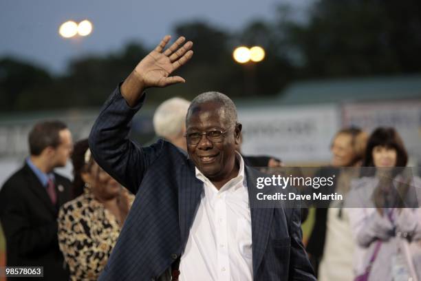 Hall of Famer Hank Aaron waves to fans during pre-game ceremonies following the opening the Hank Aaron Museum at the Hank Aaron Stadium on April 14,...