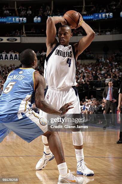 Caron Butler of the Dallas Mavericks posts up against J.R. Smith of the Denver Nuggets during the game at American Airlines Center on March 29, 2010...
