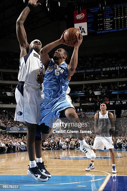 Arron Afflalo of the Denver Nuggets goes up with the ball against Brendan Haywood of the Dallas Mavericks during the game at American Airlines Center...