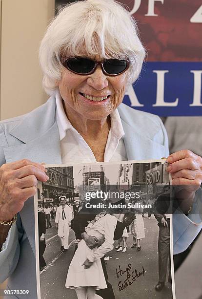 Ninety one-year-old Edith Shain poses with a photo of her famous kiss with a sailor on V-J Day at the end of World War II April 20, 2010 in San...