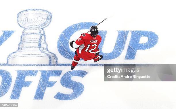 Mike Fisher of the Ottawa Senators skates over the in-ice Stanley Cup logo during warmups prior to a game against the Pittsburgh Penguins in Game...