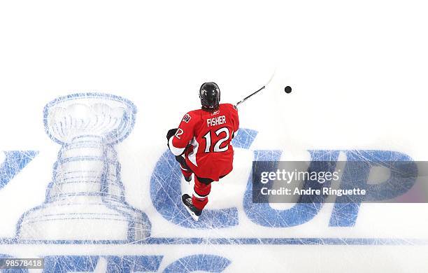 Mike Fisher of the Ottawa Senators skates over the in-ice Stanley Cup logo during warmups prior to a game against the Pittsburgh Penguins in Game...