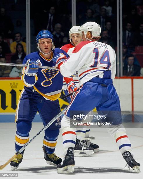 Brett Hull of the St. Louis Blues skates against Kevin Haller of the Montreal Canadiens in the 1990's at the Montreal Forum in Montreal, Quebec,...