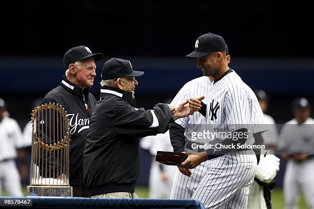 New York Yankees Derek Jeter with Yogi Berra and Whitey Ford during World Series ring ceremony before game vs Los Angeles Angels of Anaheim. Bronx,...