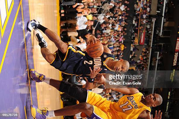 Earl Watson of the Indiana Pacers dribble drives baseline against Andrew Bynum of the Los Angeles Lakers during the game on March 2, 2010 at Staples...