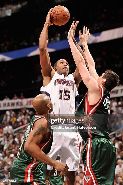 Al Horford of the Atlanta Hawks goes up with the ball against Ersan Ilyasova and Jerry Stackhouse of the Milwaukee Bucks in Game One of the Eastern...