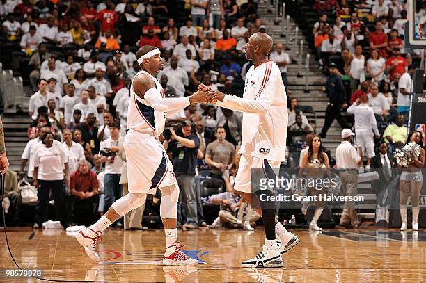 Josh Smith of the Atlanta Hawks greets teammate Joe Smith before the game against the Milwaukee Bucks in Game One of the Eastern Conference...