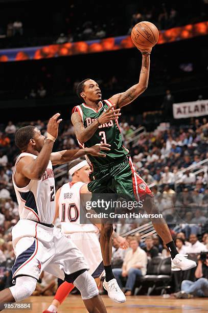 Brandon Jennings of the Milwaukee Bucks goes to the basket against Joe Johnson of the Atlanta Hawks in Game One of the Eastern Conference...