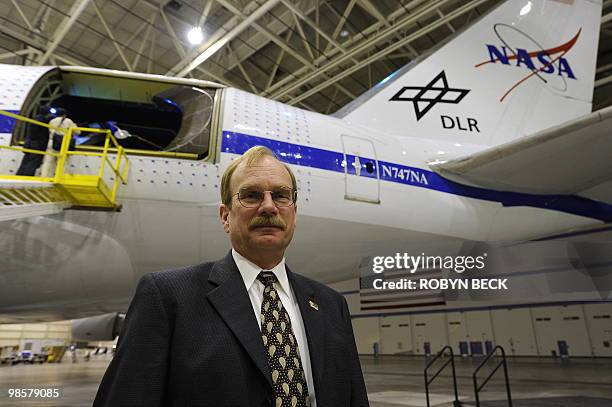 Robert Meyer Jr, program manager for NASA's Stratospheric Observatory for Infrared Astronomy program, poses below the open telescope bay of SOFIA, at...