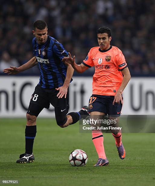 Pedro Rodriguez of Barcelona battles with Thiago Motta of Inter during the UEFA Champions League Semi Final 1st Leg match between Inter Milan and...