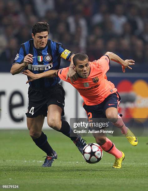 Javier Zanetti of Inter battles with Daniel Alves of Barcelona during the UEFA Champions League Semi Final 1st Leg match between Inter Milan and...