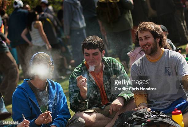 Young men smoke a marijuana cigarette during a "smoke out" with thousands of others April 20, 2010 at the University of Colorado in Boulder,...