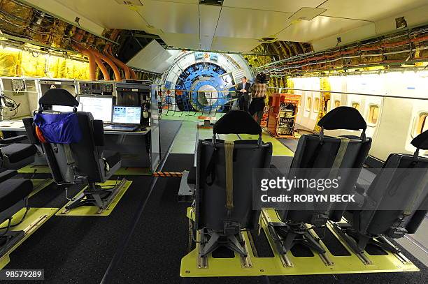 Journalists tour the cabin where astronomers will collect and analyze data aboard the Stratospheric Observatory for Infrared Astronomy aircraft, at...