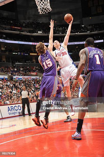 Chris Kaman of the Los Angeles Clippers puts a shot up against Robin Lopez of the Phoenix Suns at Staples Center on March 3, 2010 in Los Angeles,...