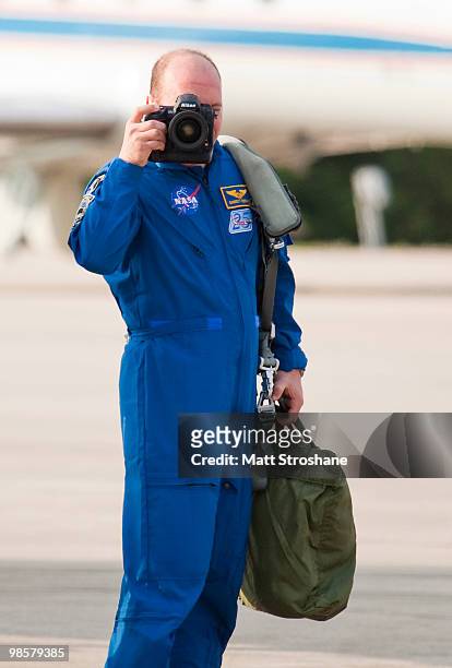 Space Shuttle Atlantis Mission Specialists Garrett Reisman photographs the media after arriving at the shuttle landing facility in their T-38 jets at...
