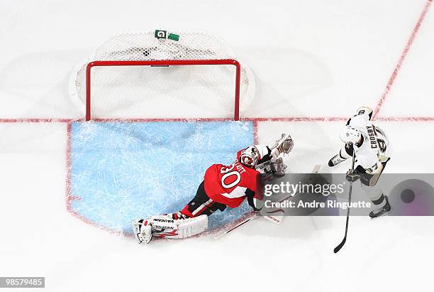 Brian Elliott of the Ottawa Senators and Sidney Crosby of the Pittsburgh Penguins watch the puck hit the back of the net for a first period power...