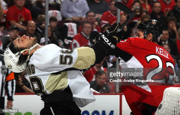 Chris Kelly of the Ottawa Senators throws a punch to Kris Letang of the Pittsburgh Penguins, snapping his head back, in Game Four of the Eastern...