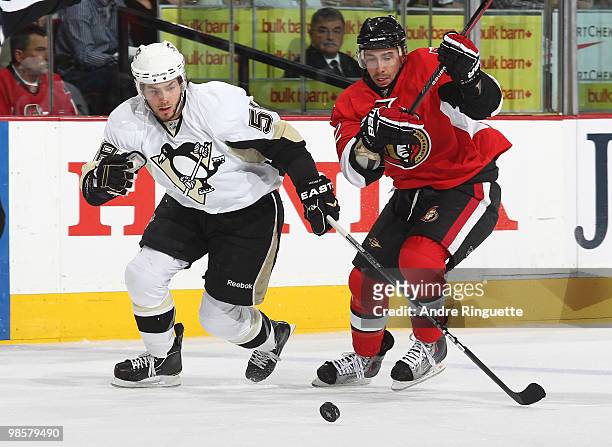 Chris Kelly of the Ottawa Senators and Kris Letang of the Pittsburgh Penguins chase after the puck in Game Four of the Eastern Conference...