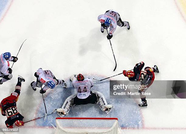 Dennis Endras, goalkeeper of Augsburg, saves the shot of Ben Cottreau of Hannover during the DEL play off final match between Hannover Scorpions and...