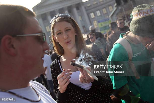 Woman passes a joint at a pro-marijuana "4/20" celebration in front of the state capitol building April 20, 2010 in Denver, Colorado. April 20th has...