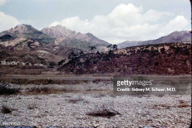 View, across the 38th parallel north, of a mountainous landscape, North Korea, January 1952. The parallel was the demarcation of the border between...