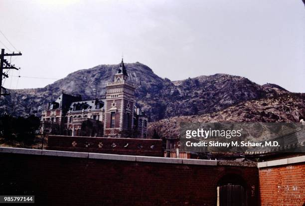 View, over a wall, of a building on a hill, Seoul, South Korea, 1952. The original caption identifies the building as the 'German Embassy.