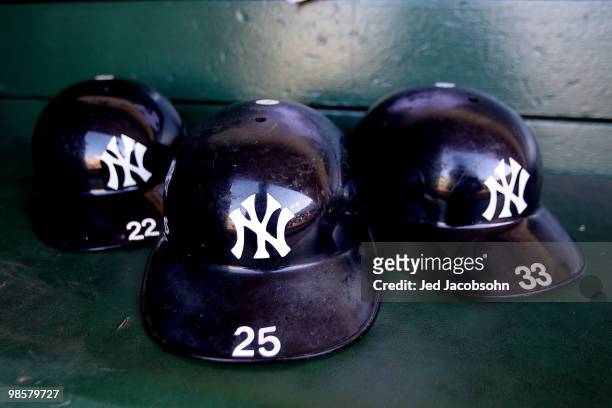 Helmets of the New York Yankees sit in the dugout against the Oakland Athletics during an MLB game at the Oakland-Alameda County Coliseum on April...
