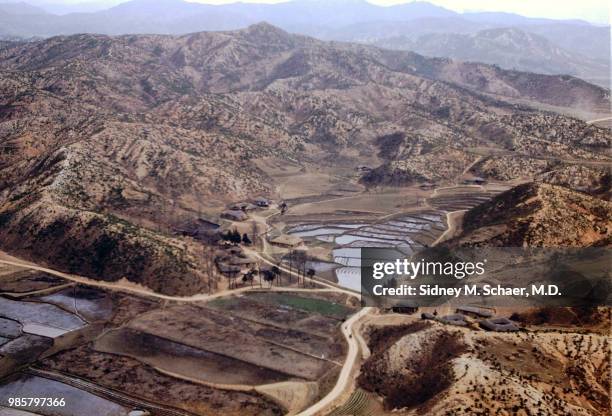 Aerial view of rice paddies in a valley, South Korea, January 1952.