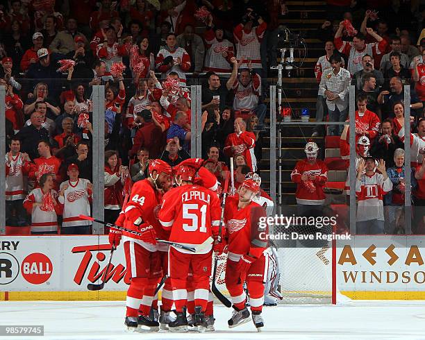 Fans cheer as Todd Bertuzzi of the Detroit Red Wings gets congratulated by teammates Valtteri Filppula and Brian Rafalski for a goal on the Phoenix...