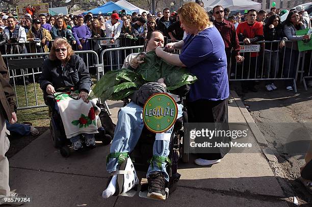 Tracey Wood lights a pipe filled with medical marijuana for her boyfriend Micah Moffet at a pro-marijuana "4/20" celebration in front of the state...