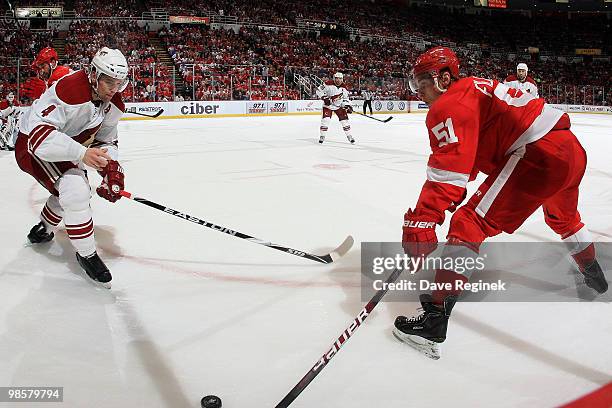 Valtteri Filppula of the Detroit Red Wings tries to keep the puck away from Zbynek Michalek of the Phoenix Coyotes as he tries to put his glove back...