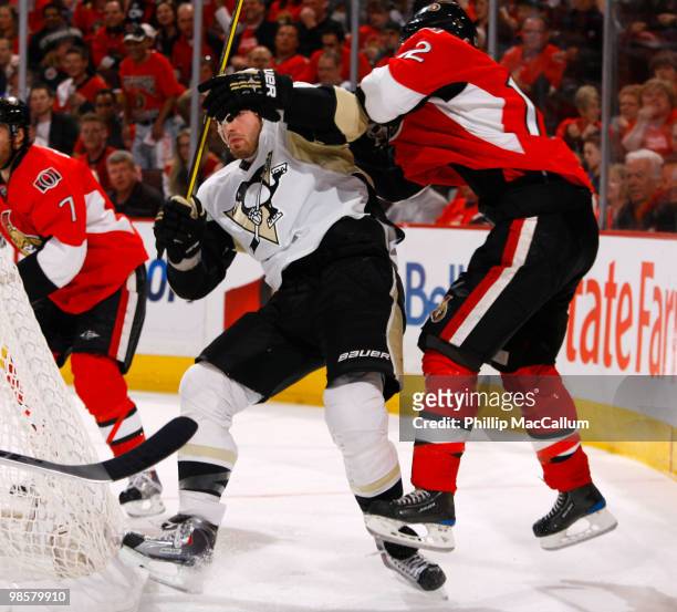 Mike Fisher of the Ottawa Senators throws a bodycheck on Brooks Orpik of the Pittsburgh Penguins during Game 4 of the Eastern Conference Quaterfinals...