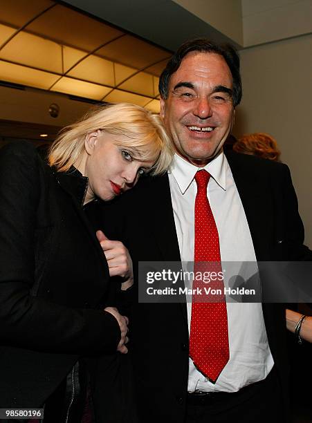 Actress Courtney Love and Director Oliver Stone pose for a photo at the after party for "South of the Border" premiere at the Walter Reade Theater on...