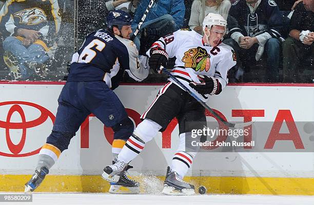 Shea Weber of the Nashville Predators checks Jonathan Toews of the Chicago Blackhawks in Game Three of the Western Conference Quarterfinals during...