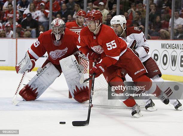 Niklas Kronwall of the Detroit Red Wings tries to control the puck in front of Robert Lang of the Phoenix Coyotes during Game Four of the Western...