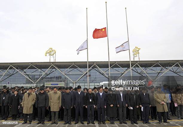 Airport staff stand in silence to mourn the earthquake victims at the Xining airport, in China's northwestern province of Qinghai on April 21, 2010....