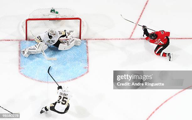 Matt Cullen of the Ottawa Senators shoots the puck past Marc-Andre Fleury of the Pittsburgh Penguins for a power play goal as Maxime Talbot looks on...