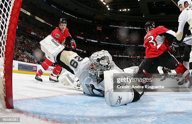 Marc-Andre Fleury of the Pittsburgh Penguins gets turned around in his crease to protect his net against Chris Neil of the Ottawa Senators in Game...
